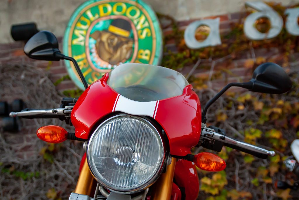 Red Ducati Scrambler parked in front of Muldoon's Irish Pub in Orange County