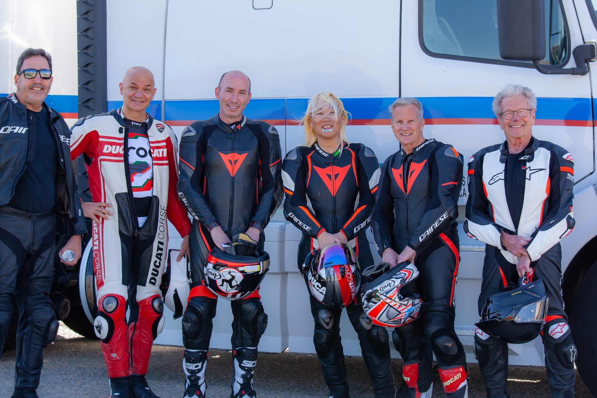 DROC track days at Streets of Willow 3 Six DROC riders in racing leathers pose together beside a white truck before riding at Streets of Willow, April 2022