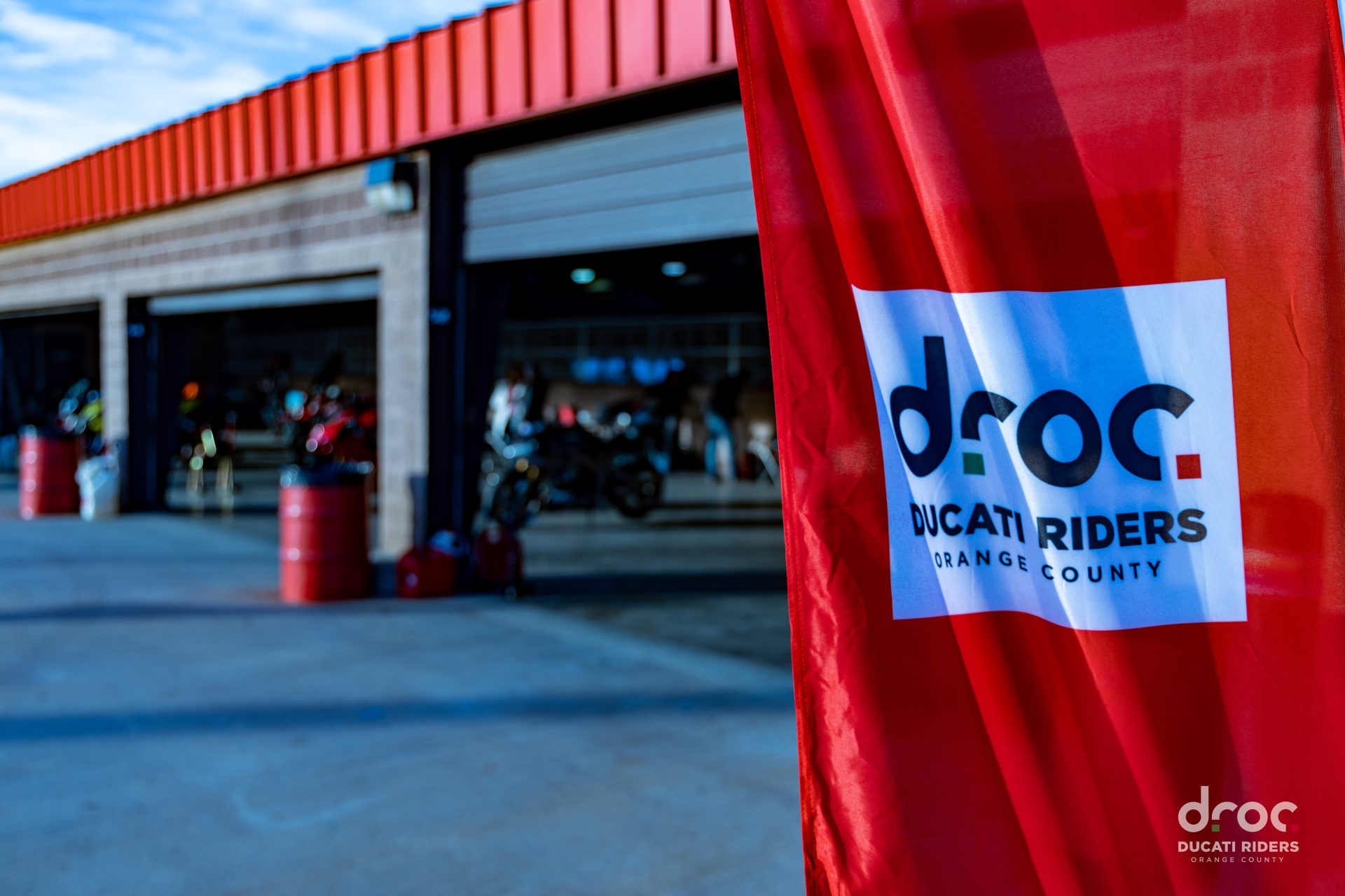 DROC flag in front of a garage with motorcycles parked inside