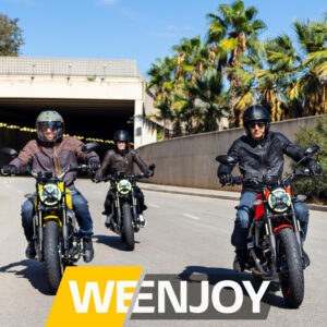 Ducati Scrambler riders cruising through a sunny Orange County street with palm trees in the background