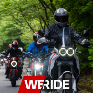 Ducati Multistrada leads a group ride through lush greenery in Orange County, showcasing camaraderie among riders