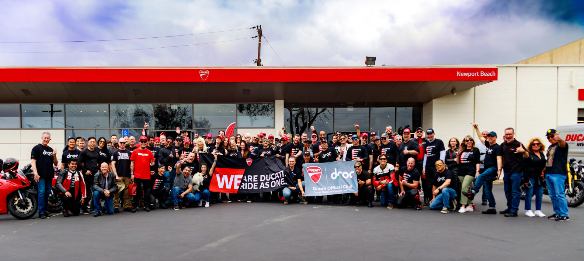About Ducati Riders of Orange County, its mission, and vision with a portrait of club members in front of our sponsor Ducati Newport Beach