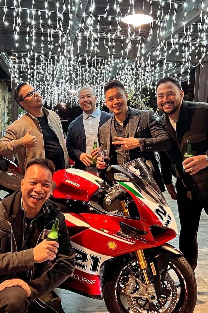 Ducati Panigale V4 at DROC 2024 Holiday Party with members celebrating under festive lights