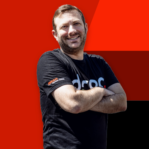 DROC team member proudly representing Ducati in Orange County with a confident smile and arms crossed