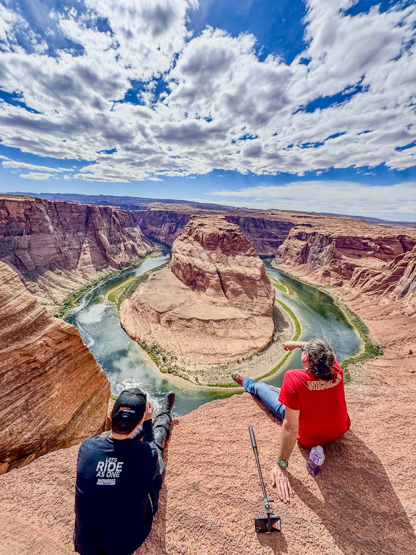 Team members enjoying the scenic view at Horseshoe Bend, surrounded by stunning rock formations and blue skies