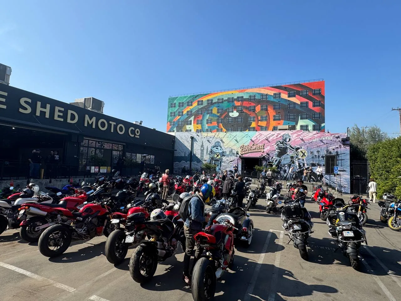 6th Street Viaduct and DTLA rides 3 Ducatis parked in front of the painted wall at Bike Shed Moto Co in the Los Angeles Arts District on Italian bike day