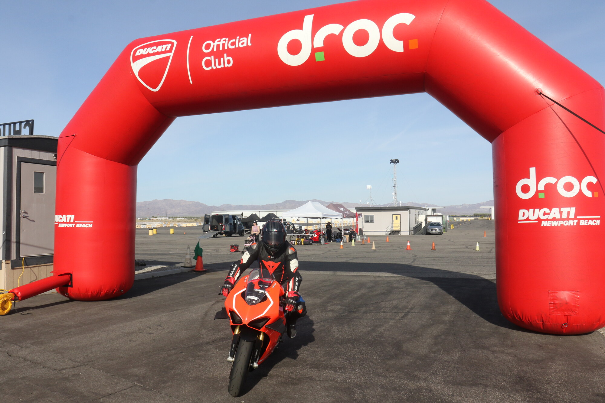 Jun Valenton: "Be very, very cautious, because it's very, very addicting" 2 Jun Valenton riding his red Ducati Panigale V4 out under the DROC arch at Chuckwalla Valley Raceway