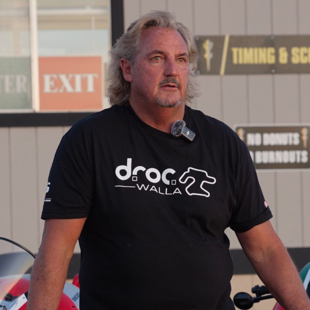 DROC member Michael Voorhees in a DROC Chuckwalla shirt beside his Ducati Panigale V4, filmed for Voices of the Track