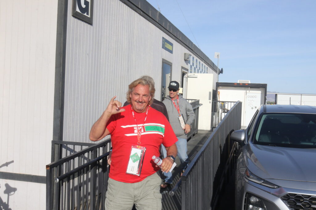 DROC member Michael Voorhees in a red club shirt in the paddock at Chuckwalla Valley Raceway