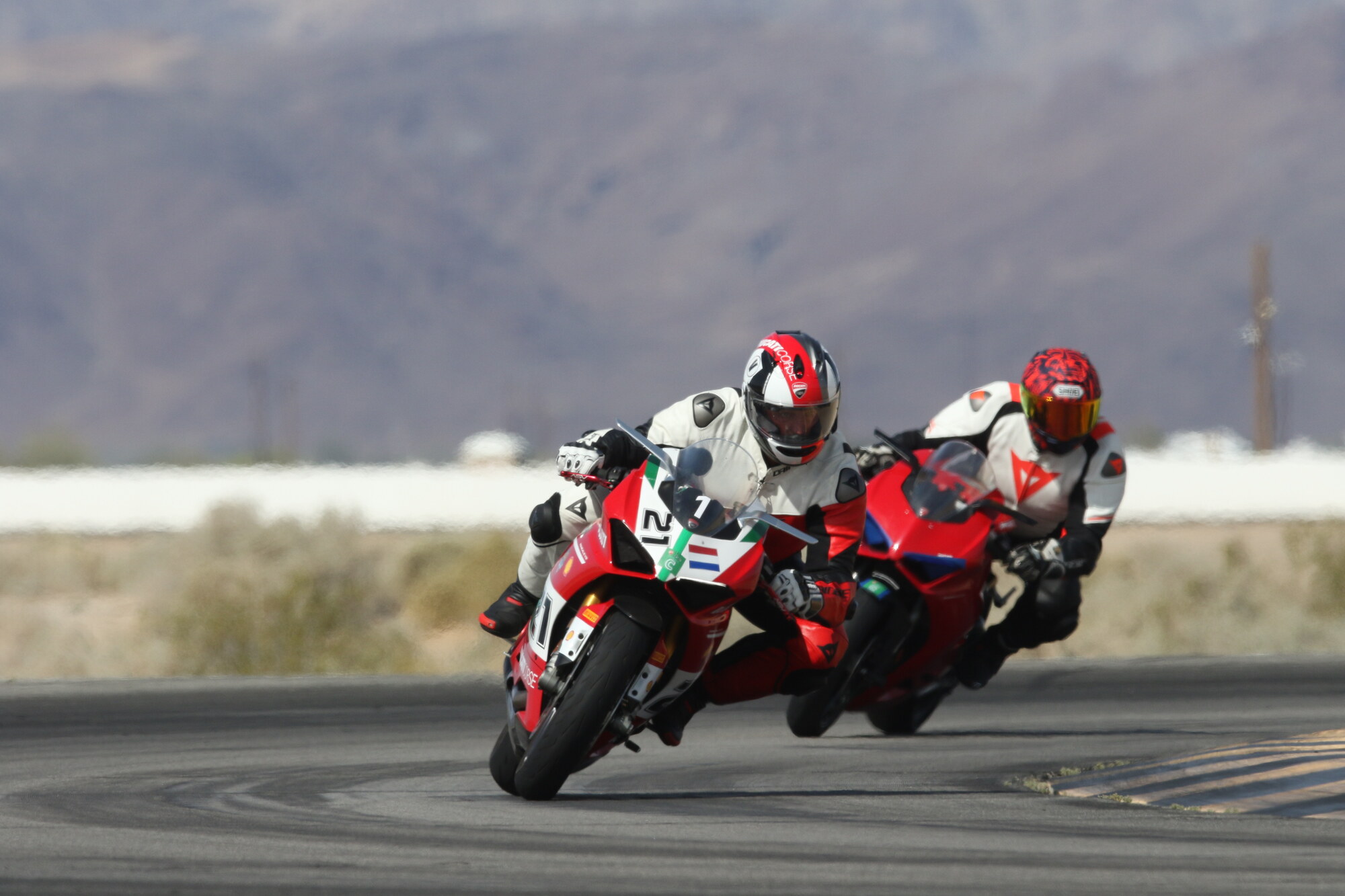 Michael Voorhees and another DROC rider cornering together on Ducati Panigale V4s at Chuckwalla