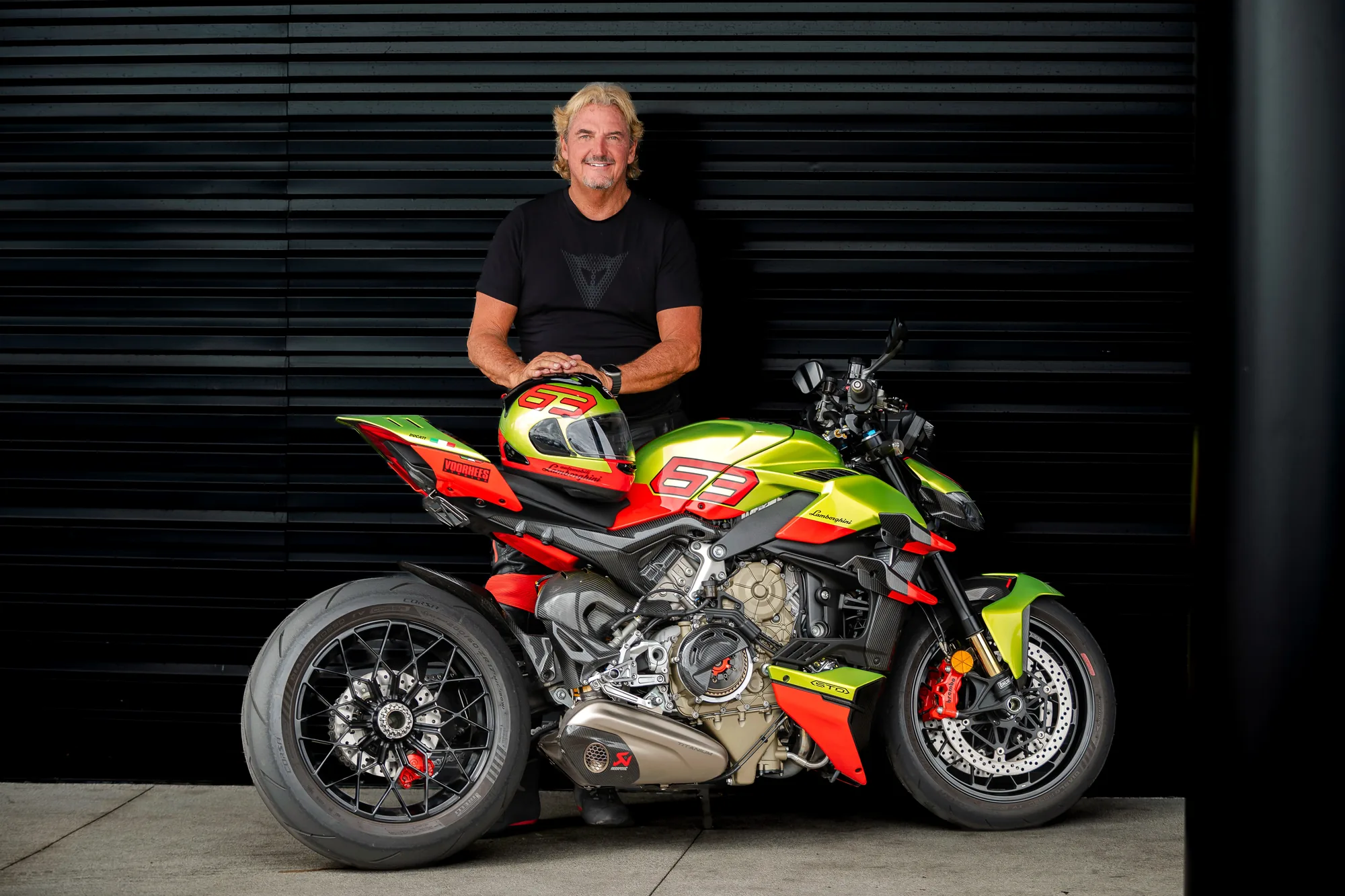 Michael Voorhees standing behind his Ducati Streetfighter V4 Lamborghini with his number 93 helmet resting on the tail