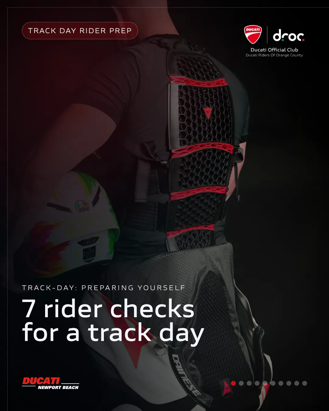 Rider in protective gear preparing for a track day with a colorful helmet and Dainese suit