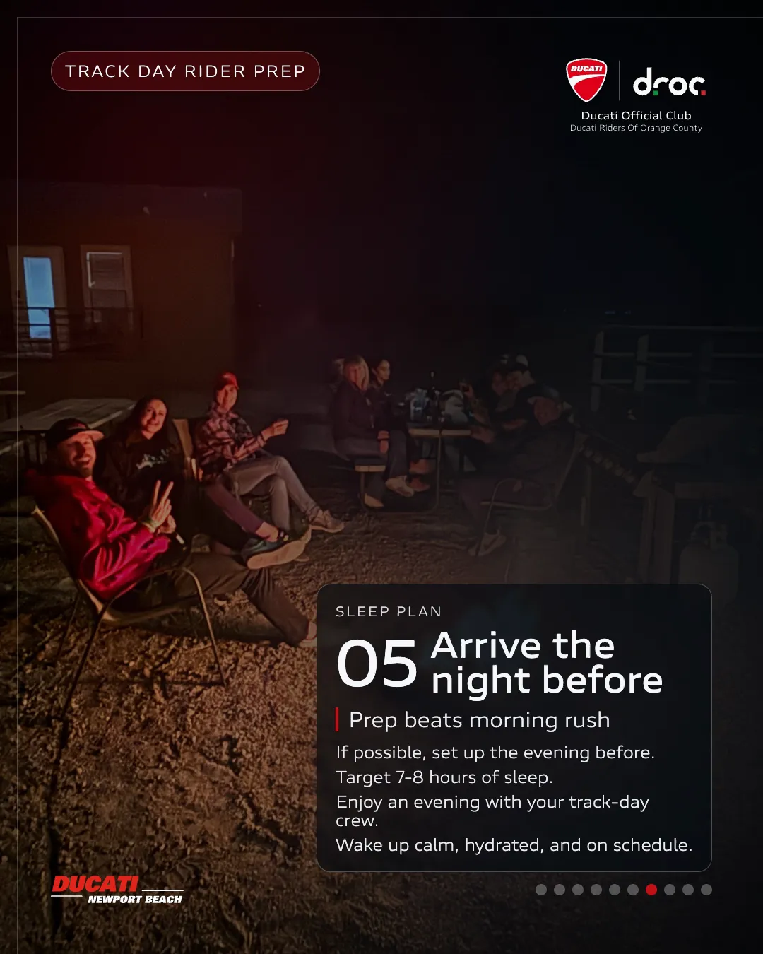 Ducati track day prep with riders relaxing around a campfire, enjoying camaraderie and evening discussions