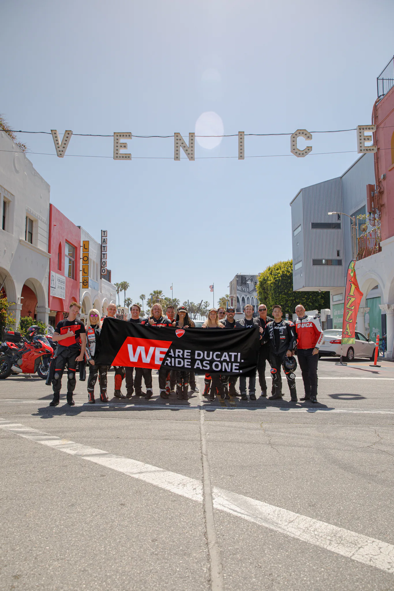 6th Street Viaduct and DTLA rides 4 Ducati riders gather in Venice, holding a banner that reads