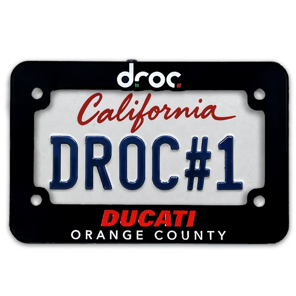 Black DROC motorcycle license plate frame, droc logo on top and Ducati Orange County below, shown around a sample California plate reading DROC#1